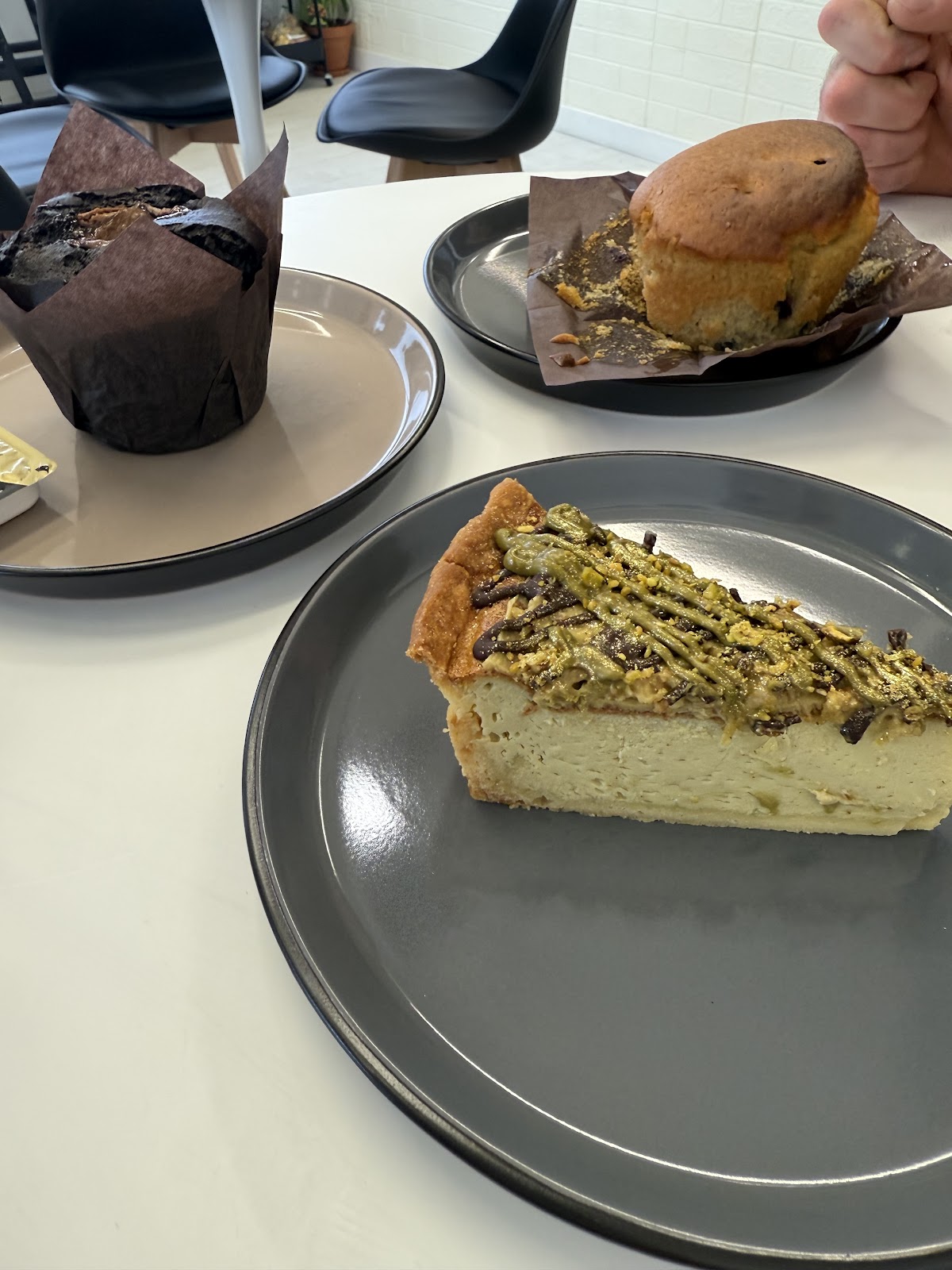 Tart slice, muffins and a scone on the table